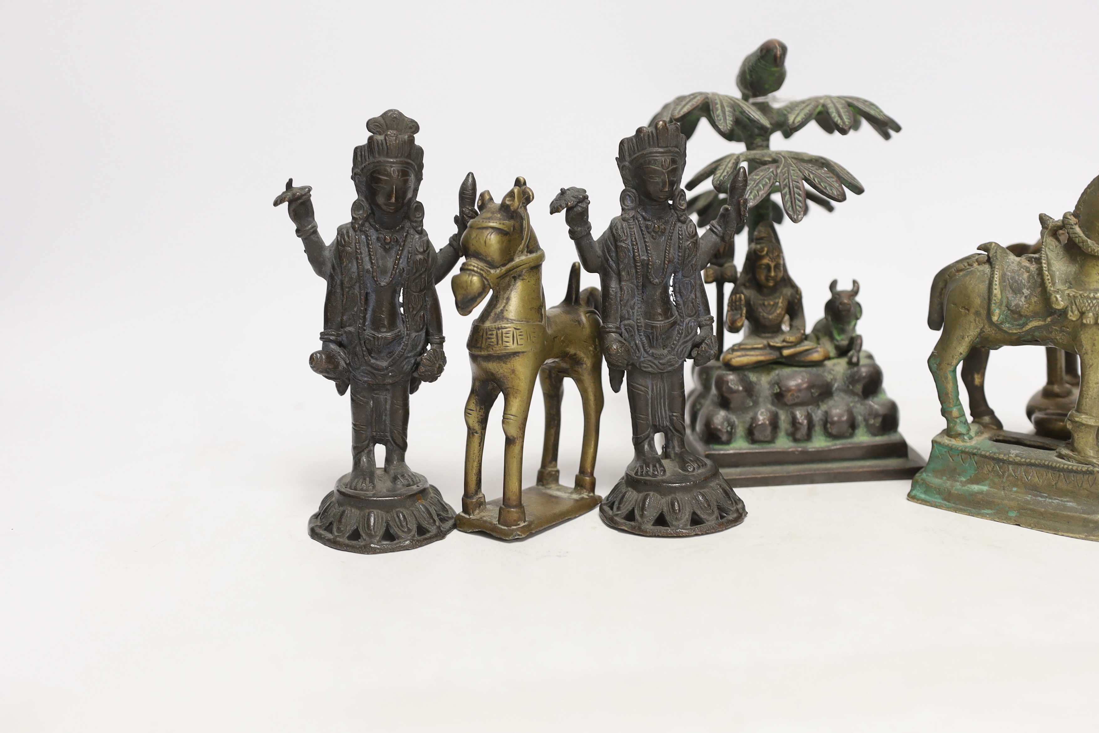 Six Indian bronze/brass ornaments; Shiva sitting under a bael tree with a bird, 17cm, two figures of Lord Vishnu and three horses